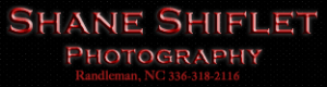 A photo of a red and black logo for Shane Shiflet photography logo